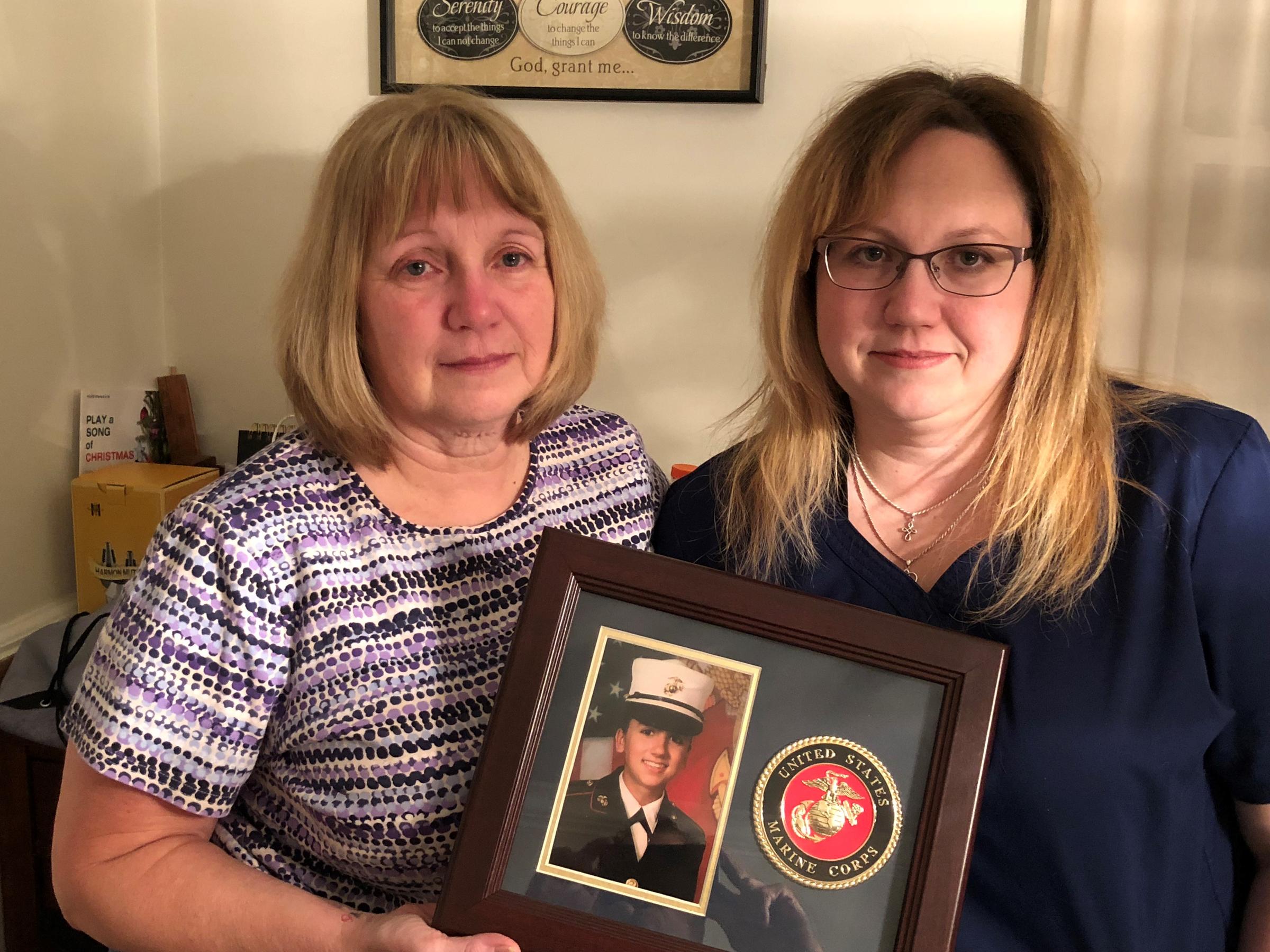 Deana Martorella Orellana's mother, Laurel Martorella (left), and Orellana's sister, Robin Jewell, hold her Marine Corps photo. Orellana killed herself a year after leaving the Marines. She had agreed to undergo counseling the day she died.