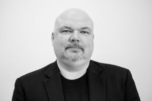 A black and white photo of Jason Korb